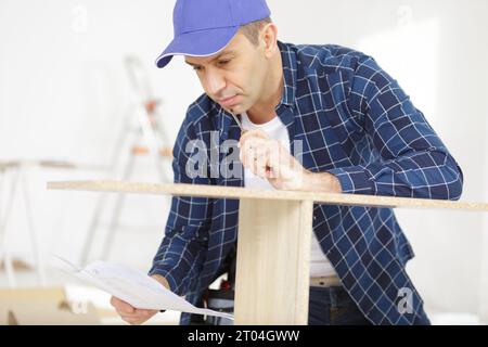 a man is assembling furniture Stock Photo