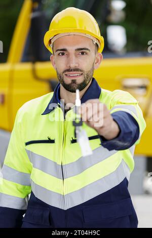 worker with hardhat on showing key Stock Photo