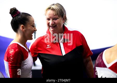 02 October 2023, Belgium, Antwerpen: Gymnastics: World Championships 2023, Women, Qualification, Sportpaleis. Bianca Frysak from Austria (l) talks to Austria's national coach Gabriele Frehse (r) after her routine. Former Chemnitz coach Frehse and the German Gymnastics Federation (DTB) have settled their dispute. There had been a very open discussion in Chemnitz with Secretary General Zinnkann and Sports Director Gutekunst, said Frehse, who has been women's national coach in Austria since July, on the sidelines of the World Championships in Antwerp. (to dpa 'Dispute between coach Frehse and gym Stock Photo