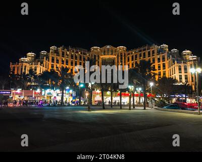 Night time exterior view of the Queen Of Sheba, temple dome hotel shape with natural light pouring in from the windows above Stock Photo