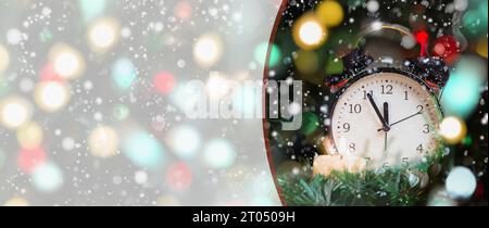 The alarm clock indicates that in five minutes it will be twelve o'clock, the new year. Five minutes to twelve, New Year's Eve. Close up. New Year's b Stock Photo