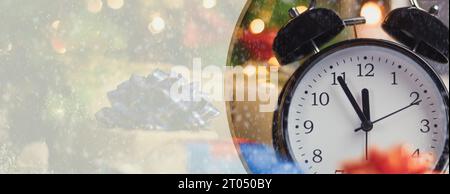 The alarm clock indicates that in five minutes it will be twelve o'clock, the new year. Five minutes to twelve, New Year's Eve. Close up. New Year's b Stock Photo