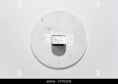 Strasbourg, France - September 2023: The Ordinary skincare brand by Deciem. Vitamin C Powder on marble circle white background. Clean minimalist high Stock Photo