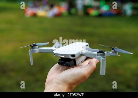 A small foldable drone on the pilot's hand before flight Stock Photo