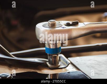 Close up of a socket wrench tightening a nut, Torque wrenches are used in car repairs in auto repair shops. Automotive maintenance service concept Stock Photo