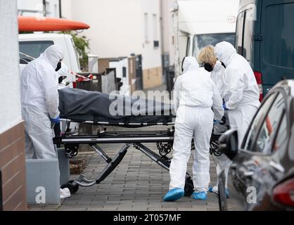 Police Officers, Forensics And Morticians Carry Corpses Out Of A House ...