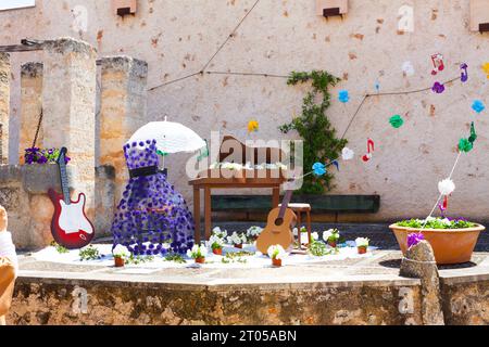 Decoration, consisting of two guitars, a piano and a violet dress with some musical notes on the background, on 'Costitx en Flor' (Costitx in bloom) F Stock Photo