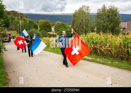 Villagers dressed in traditional costumes proudly take part in the annual Alpine cow parade in Ligniéres village, Jura mountains, Switzerland. Stock Photo