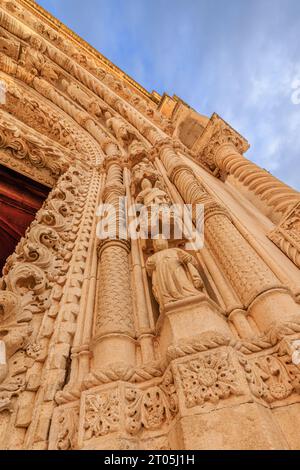 detail of the richly embellished doorway of western portal of sibenik cathedral looking upwards at the row of statues of the apostles Stock Photo
