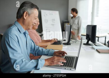Senior woman excited to learn how to work on laptop Stock Photo