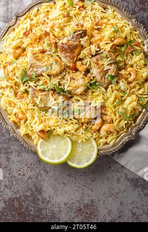 Pilaf Kacchi Biryani Bangladeshi Bast Food closeup on the plate on the table. Vertical top view from above Stock Photo