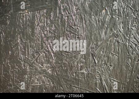 Pressed sawdust texture. Background made of building material. Pressed material. Chaotic combination of sawdust. Stock Photo