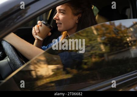 Close-up portrait busy successful business lady riding car office drinking coffee good morning traffic jam Stock Photo