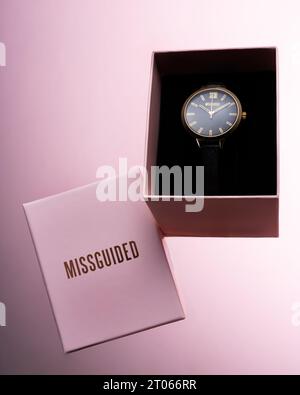 Missguided watch in pink packaging box on pink background Stock Photo