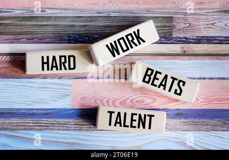 Conceptual words Hard work beats talent on wooden blocks and beautiful vintage background. Motivational hard work beats talent in business concept. Stock Photo