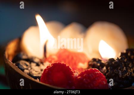 candle looking like fruit bowl in coconut shell with diya lamps in the background on festival of diwali Stock Photo