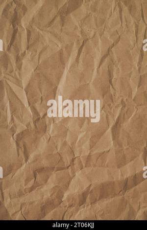 Trendy brown crumpled paper texture. Minimal background and texture concept. Flat lay, top of view background. Copy space for text. Stock Photo