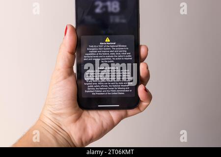 Phone user receives national security alert on cell phone device. A US government emergency alert exercise that sent a test message to every TV, radio and cell phone in the country. Starting at approximately 2:20 pm ET on Wednesday, the federal government began conducting a nationwide test of its Emergency Alert System and Wireless Emergency Alerts. The EAS portion of the test sent an emergency alert to everyone radios and televisions, while the WEA portion of the exercise sent an alert to all consumers' cell phones. The testing was being conducted by the Federal Emergency Management Agency in Stock Photo