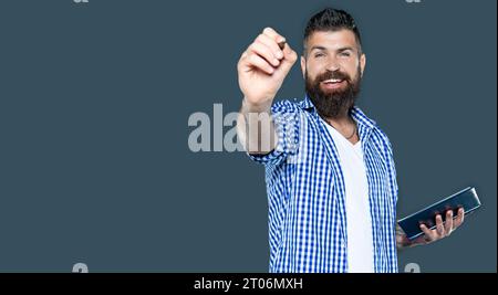 cheerful bearded man making notes in book point on you Stock Photo