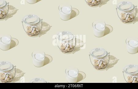 Trendy pattern made of chocolate cookies and glass of milk on pastel cream background. Minimal food and drink concept. Creative pattern idea. Stock Photo