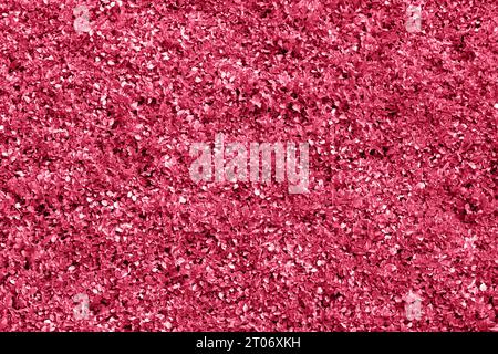 Trendy color of 2023 - Viva Magenta. Natural background, texture . Carpet of fresh young spring grass toned in color of year Viva Magenta. Closeup. To Stock Photo