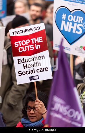 Protest march demonstrating against the cuts to and privatisation of the National Health Service in the UK. Teachers say stop the cuts placard Stock Photo