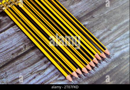 Row of pencils, a pencil is a writing or drawing implement with a solid pigment core in a protective casing that reduces the risk of core breakage, an Stock Photo