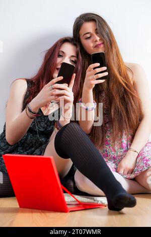 Between real and virtual sociability, two young women cherish moments before the world's conforming pressures Stock Photo