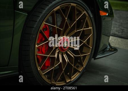 Close up of luxury sport car wheel. Wheel brake disc. Golden glossy alloy wheels on Lamborghini. Close up of rims from a sports car. Vancouver,Canada- Stock Photo