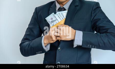 businessman or corrupt politician is offering bribes that are given in the form of dollar cash To do illegal business Stock Photo