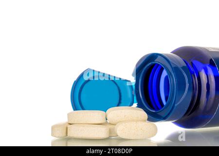Several medical pills with plastic container, macro, isolated on white background. Stock Photo