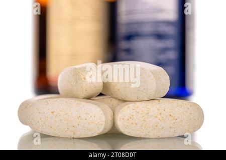 Several medical pills with plastic container, macro, isolated on white background. Stock Photo