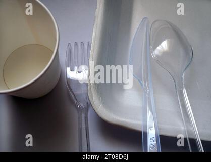 Single-use plastic cutlery. Plastic containers and trays used in takeaways. Stock Photo
