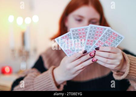 cheerful girl sitting on chair in lotus pose, holding laptop and credit card  near collection of shoes on grey background Stock Photo | Adobe Stock