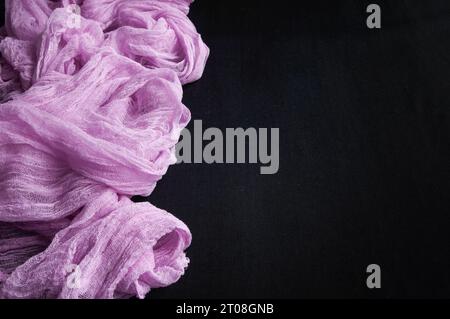 Lilac gauze fabric on a black background. Place for text. Stock Photo
