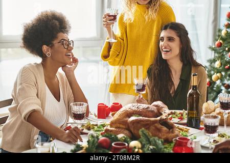 cropped view of lgbt couple and their multicultural family having great time at Christmas lunch Stock Photo