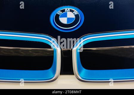 bmw ornament on the black hood of a white i3 electric car. outdoor close up Stock Photo