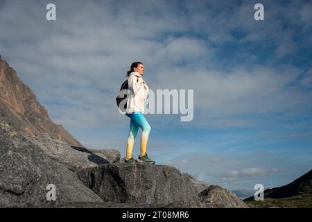 A woman hiking in the mountains. Enjoying the view Stock Photo