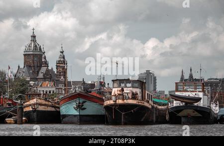 boats sitting in one of the canals in Amsterdam Stock Photo