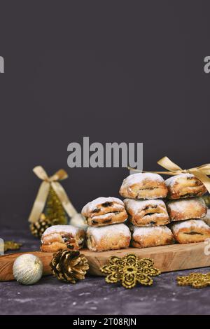 Stollen cake pieces, a small German fruit bread with nuts, spices, and dried fruits with powdered sugar traditionally served during Christmas time Stock Photo