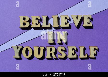 Believe in Yourself, words in wooden alphabet letters isolated on purple background Stock Photo