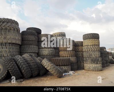 Scrap tires for recycling. End-of-life vehicle wheels in various sizes. Stock Photo