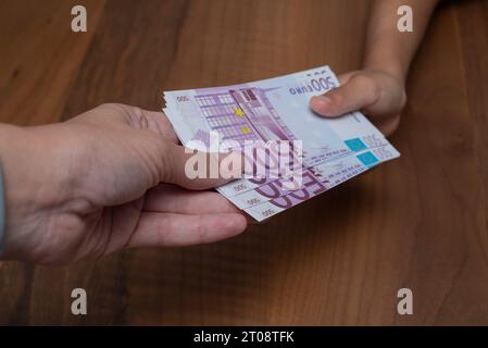 young boy holding lot of cash of euro banknotes.Personal money concept. Stock Photo