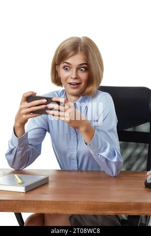 blonde business woman using phone in the office Stock Photo