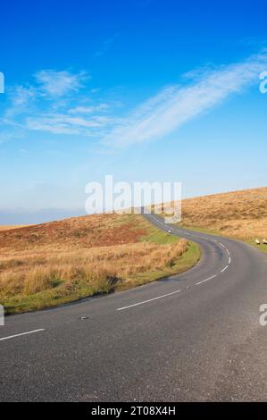 Empty road crossing Dartmoor National Park, Devon, UK - John Gollop Stock Photo