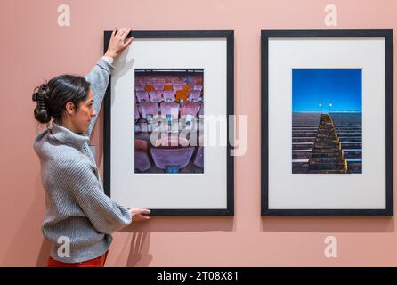 Scottish Portrait Gallery, Edinburgh, Scotland, UK, 05 October 2023, New exhibition: Making Space: Photographs of Architecture. The National Galleries of Scotland’s newest exhibition, displays a range of photographic styles, formats and processes. Pictured:  a member of staff adjusts photographs by photographer Colin McPherson. Credit: Sally Anderson/Alamy Live News Stock Photo