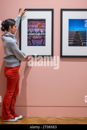 Scottish Portrait Gallery, Edinburgh, Scotland, UK, 05 October 2023, New exhibition: Making Space: Photographs of Architecture. The National Galleries of Scotland’s newest exhibition, displays a range of photographic styles, formats and processes. Pictured:  a member of staff adjusts photographs by photographer Colin McPherson. Credit: Sally Anderson/Alamy Live News Stock Photo