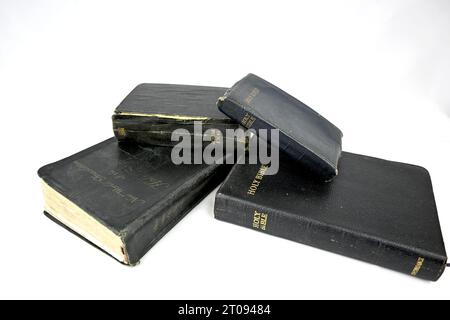 Multiple old bibles on a white background Stock Photo