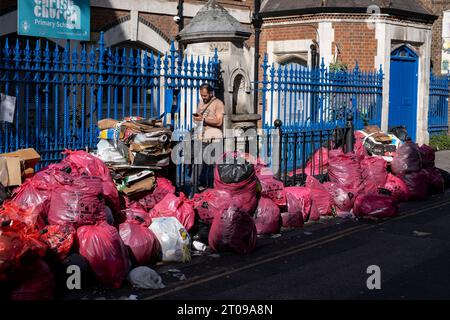 Refuse piled up along Brick Lane during four weeks of strike action by waste service workers in Tower Hamlets on 25th September 2023 in East London, United Kingdom. Tower Hamlets Council waste service workers and street cleaners are currently on strike from 18th September to 1st October. More than 200 refuse workers have downed tools after rejecting the a flat pay increase of £1,925. The industrial action has now been extended by a further two weeks after an improved offer was not tabled by management in the ongoing national pay dispute. Stock Photo