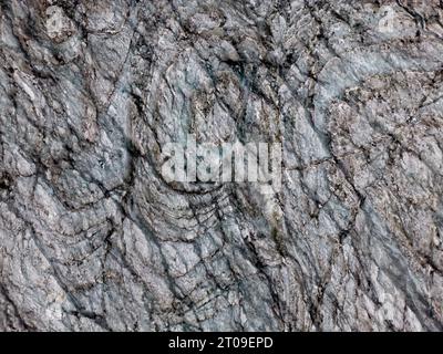 Full frame background of dry uneven texture of old gray colored stone surface Stock Photo